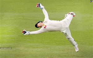 Australian Cricketer, Matthew Wade taking a difficult catch as Wicket-keeper